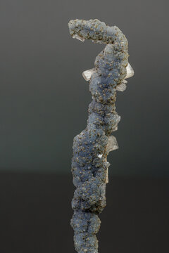 Macro mineral stone chalcedony with stelbite on a gray background
