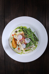 Pike perch with white sauce and beans. A white plate. Menu for the restaurant. A dish of eyelash fish. Healthy and low-calorie food. Top view with copy space. Flat lay.