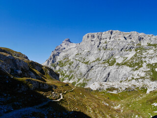 Fototapeta na wymiar Hiking path through rocky landscape surrounded by Sulzfluh and Scheinfluh in Praettigau, Graubuenden, Switzerland.