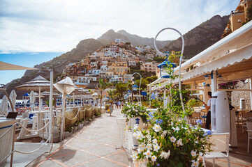 Panorama of Positano city in Italy. Warm summer weather, sunny day. Coastline with restaurants and...