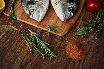 sea fish fresh ingredients lemon on wooden board