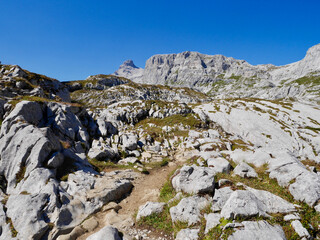 Hiking path through rocky landscape with Sulzfluh in the background, Praettigau, Graubuenden, Switzerland.