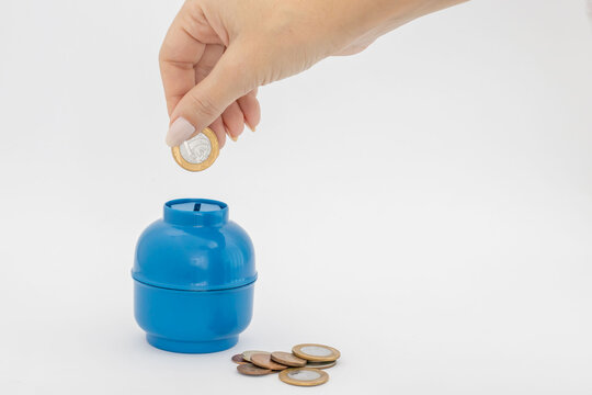 kitchen gas cylinder and Brazilian reais banknotes and coins isolated on white background "vale g&aacute;s"