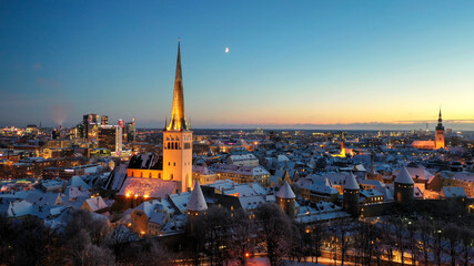 Aerial view to the historic Tallinn old down hall and square with the seasonal Christmas market 