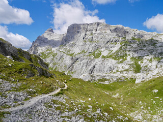 Fototapeta na wymiar Hiking path in the Swiss Alps with Sulzfluh in the background. Praettigau, Grisons.