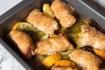 chicken rolls with smoked scamorza cheese and cooked ham and passed in breadcrumbs. Baked with bay leaf and lemon slices