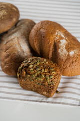Homemade bread with seeds on the table. Fresh pastries for breakfast.