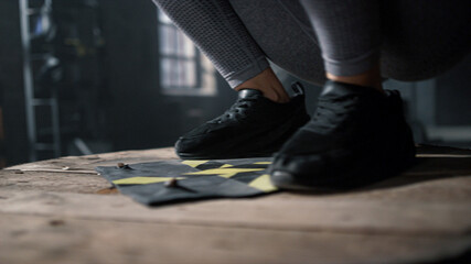 Girl legs doing set of box jumps. Woman using sport equipment for workout