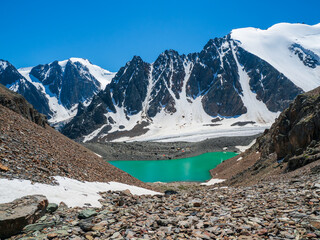 Amazing clear blue mountain lake in the Aktru Valley in Altai. Blue mountain lake on background of mountains. Atmospheric bright landscape with Blue lake in high mountain valley in highland glen.