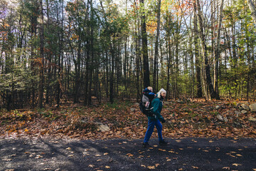 Obraz premium Grandmother hiking with her granddaughter in the woods