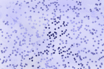 Color of the year 2022 Very Peri. Shiny stars on white and blue background. Winter abstract background in trendy color. New Year party, Christmas celebration, holidays, dreams concept. Selective focus