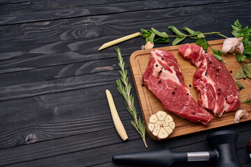 meat on wooden board vegetables and ingredients for cooking wooden background