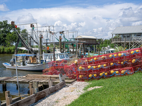 Coastal fishing boats and crab traps on the bayou in Southern Louisiana on June 28, 2014 in Delacroix, Louisiana, USA
