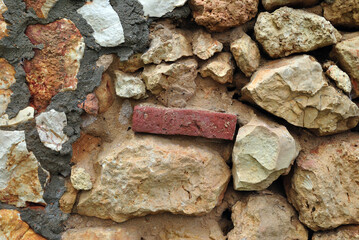 Close Up of Rough Textured Rocks  in Ancient Stone Wall