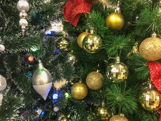 Fragment of a Christmas tree close-up. Christmas toys and balls on the Christmas tree. Festive Christmas toys. Christmas decorations. Christmas and New Year.