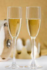 two glasses of cava on golden background