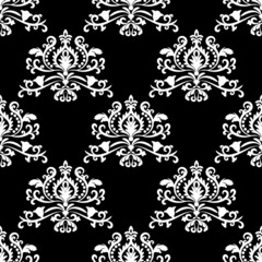 Oriental vector pattern with white arabesques on black background. Floral wallpaper.  Vintage lace seamless pattern. For fabric, wallpaper, tiles or packaging.