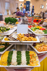 fish slicing and various dishes on the buffet in the restaurant