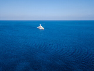 Aerial view on white yacht in blue sea