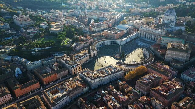 Aerial drone video of Saint Peter's square in front of world's largest church - Papal Basilica of St. Peter's, Vatican - an elliptical esplanade created in the mid seventeenth century, Rome, Italy
