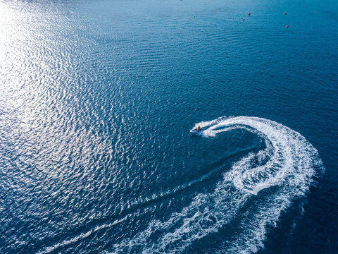 Aerial view on jet ski in azure sea. Water sport