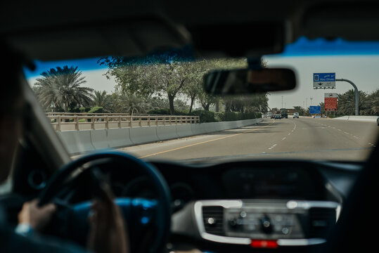 Driving a Car on the Abu Dhabi Road Highway with Dashboard Speedometer in Front of the Steering Wheel 
