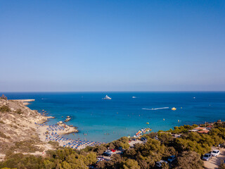 Aerial view on beautiful beach with sun loungers near azure sea