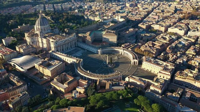 Aerial drone video of Saint Peter's square in front of world's largest church - Papal Basilica of St. Peter's, Vatican - an elliptical esplanade created in the mid seventeenth century, Rome, Italy