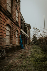 Fototapeta na wymiar Abandoned school ruins on a cloudy day in New Orleans