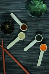 Table with spices, aromas, chopsticks, plants and Asian infusions.