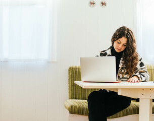 a woman working with the laptop at home