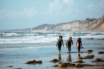 Group of women with surfboards at the beach