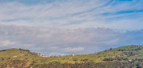 Fototapeta na wymiar Cantabrian hills and rural landscape of farmland. Valleys pasiegos in nothern Spain. Toned.