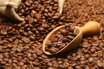 Closeup of coffee beans with scoop in mood lighting