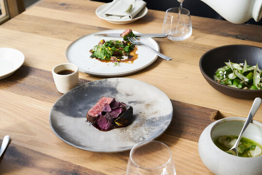 Group of fresh modern dishes for gourmet meal on a wooden table