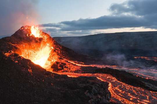 incandescent flowing volcanic lava and caldera in long expo