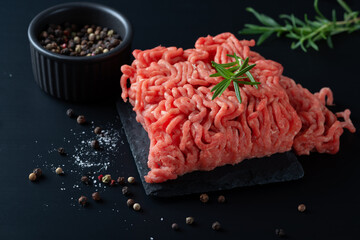 Raw minced meat on a black surface