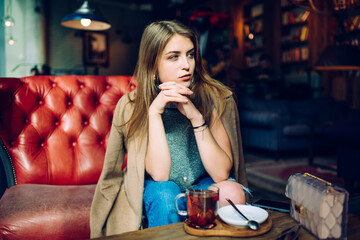 Thoughtful woman resting in cafe