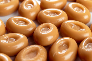 Caramel sweetmeat candies with creamy chocolate flavor. Macro. Brown butterscotch