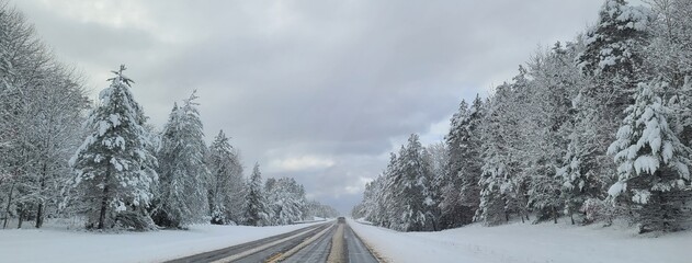 Picturesque Highway Filled with Snow and Snow Covered Evergreen Trees, Road Trips and Travel