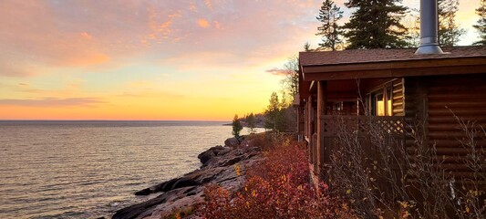 Log Cabin Sunrise or Sunset Near the Water's Edge and Near a Pine Tree Forest