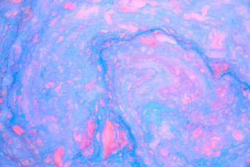 Abstract colored marble background, stains of pink and blue paint on the surface of the water. Liquid colorful backdrop.