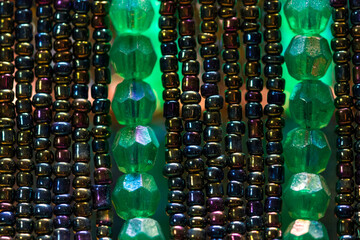 Green and tiny colored beads line up the frame