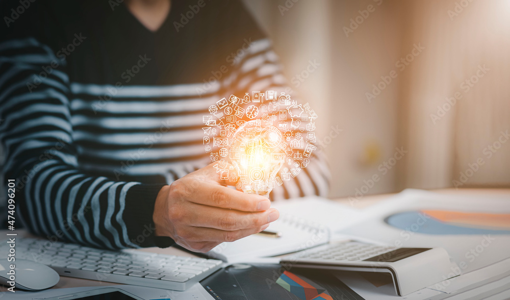 Poster creativity and innovation are keys success concept, businessman hand holding light bulb with using c