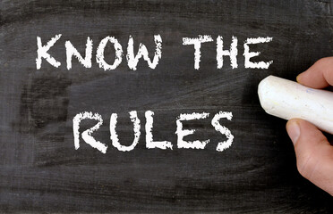 Blackboard with Know the Rules sentence handwritten