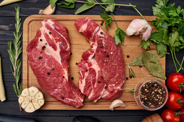 meat on wooden board vegetables and ingredients for cooking wooden background
