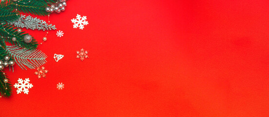 Top view of a flat lay of Christmas decorations on a red background. Concept postcard, announcement, banner. With copy space