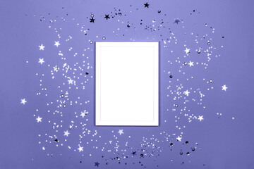 Festive background with blank white photo frame and confetti.