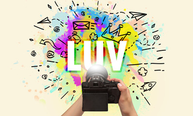 Close-up of a hand holding digital camera with abstract drawing