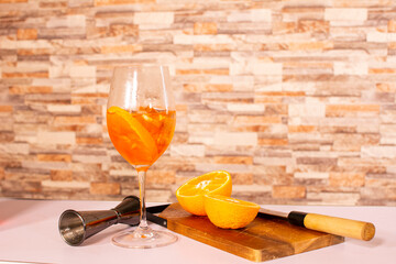 Aperol spritz cocktail in glass with oranges at the side